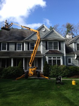 Worker Cleaning the Roof